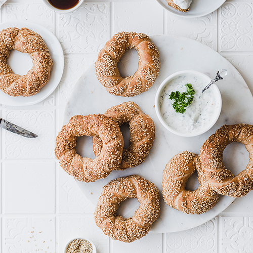 Gesündere & vegane Sesamkringel. Ein Rezept aus fluffigem Hefeteig - perfekt für Brunch & Frühstück - z.B. zur Osterzeit. • Maras Wunderland #vegan #gesundbacken #sesam #sesamkringel #sesamringe #koulouris #grünesoße #gruennesosse #dip #aufstrich